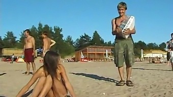 A Stunning Young Girl Disrobes And Indulges In Beach Activities